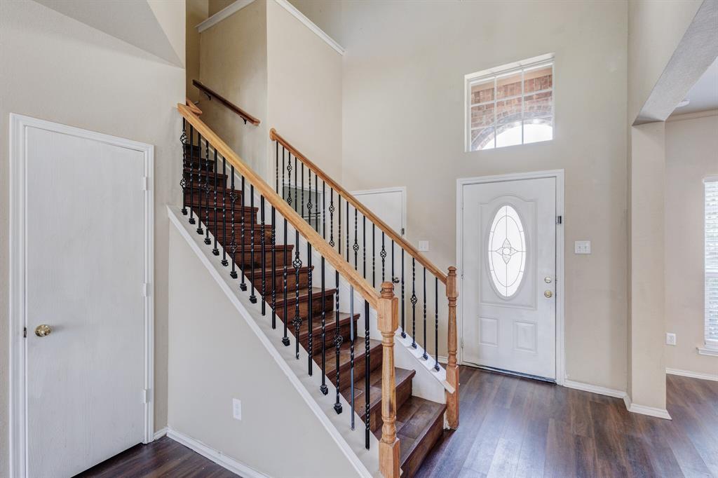 7310 Northpoint Drive Rowlett, TX 75089 - Photo 6 of 32 a view of entryway with wooden floor and stairs