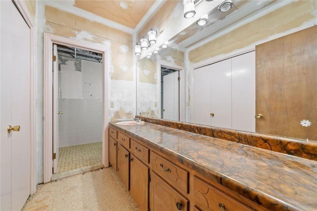 286 Hilton Way Canton, GA 30114 - Photo 38 of 59 a spacious bathroom with a granite countertop sink a mirror and a shower