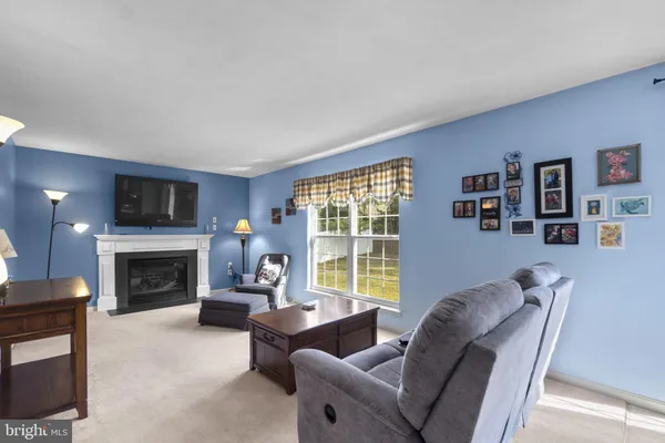 a living room with furniture a window and a fireplace