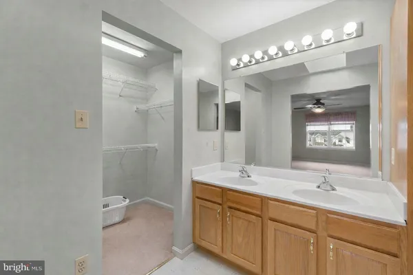 a bathroom with a double vanity sink mirror and shower