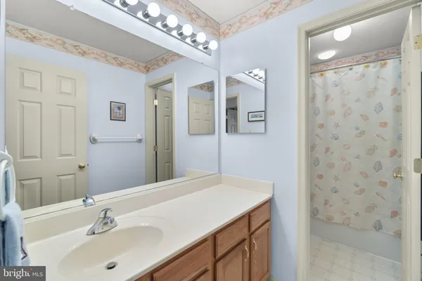 a bathroom with a sink a mirror and a shower