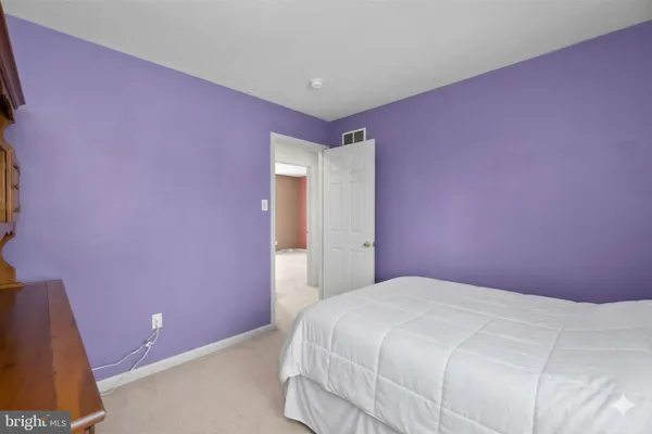 a bedroom with a bed and a mirror