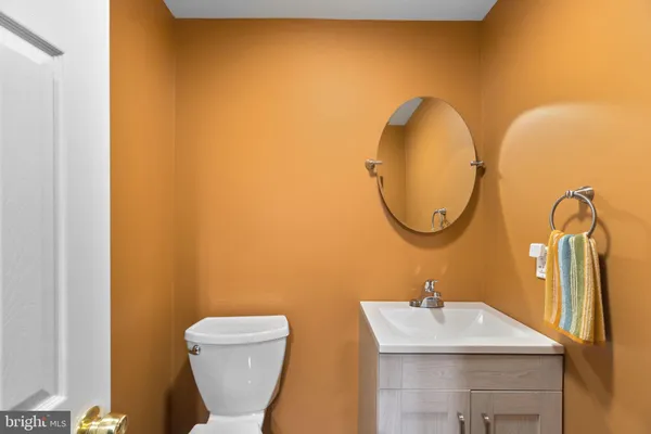 a bathroom with a sink mirror and toilet
