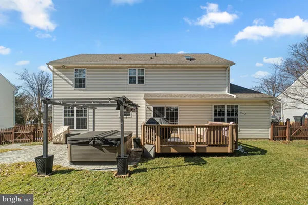 a view of a house with wooden deck and furniture
