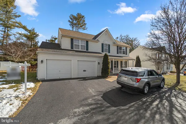 a car parked in front of house with a yard