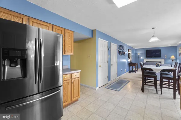 a kitchen with stainless steel appliances a refrigerator and a stove top oven