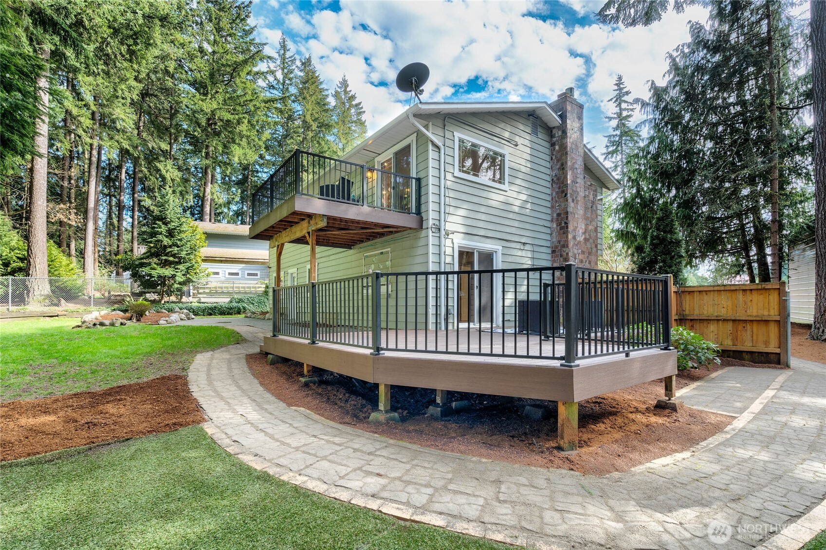 3113 198th Place Southeast Bothell, WA 98012 - Photo 27 of 32 a view of a wooden house with a small yard and large trees