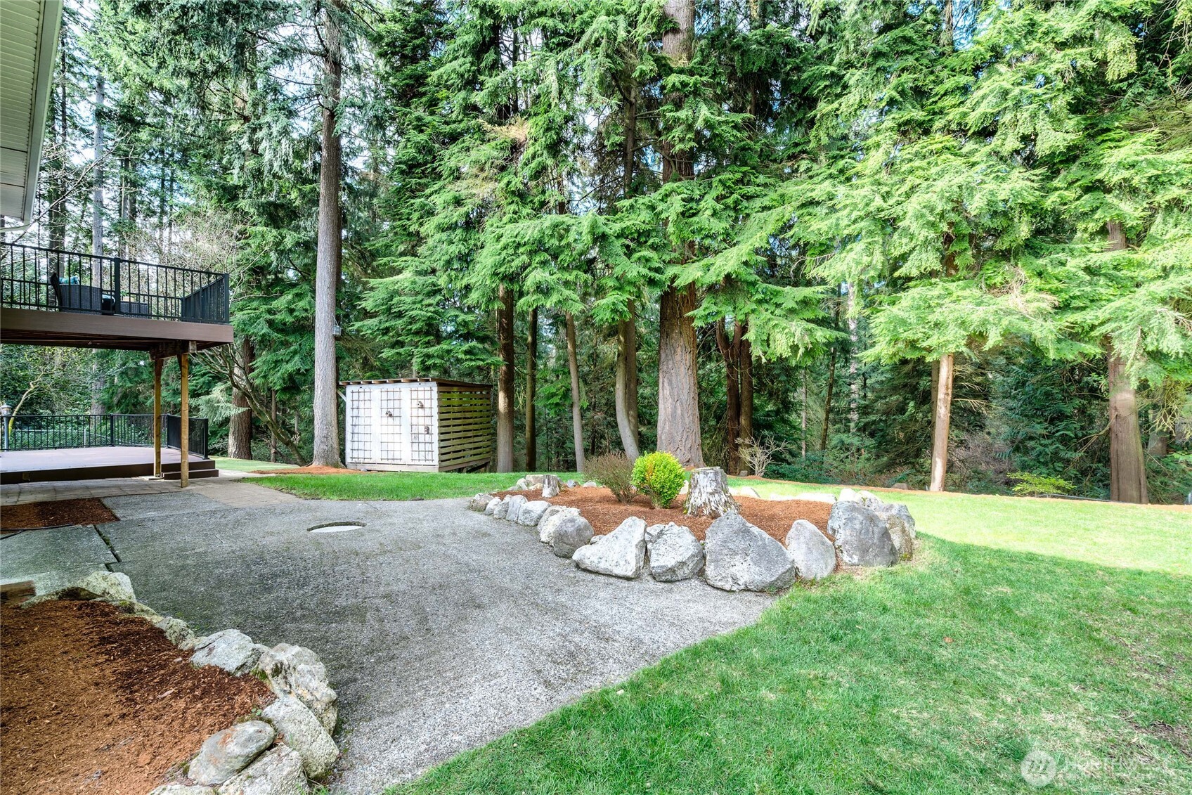 3113 198th Place Southeast Bothell, WA 98012 - Photo 28 of 32 a view of a backyard with table and chairs under an umbrella