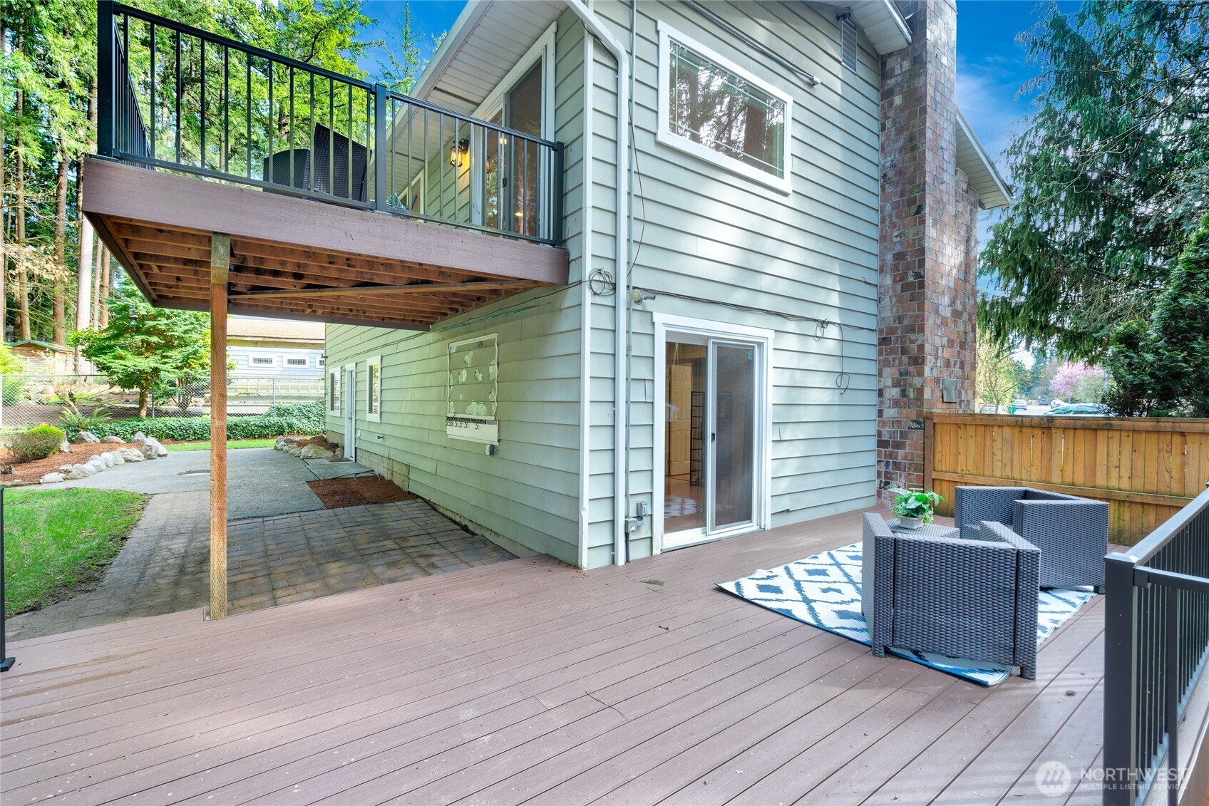 3113 198th Place Southeast Bothell, WA 98012 - Photo 30 of 32 a view of a patio with table and chairs potted plants with wooden floor and fence