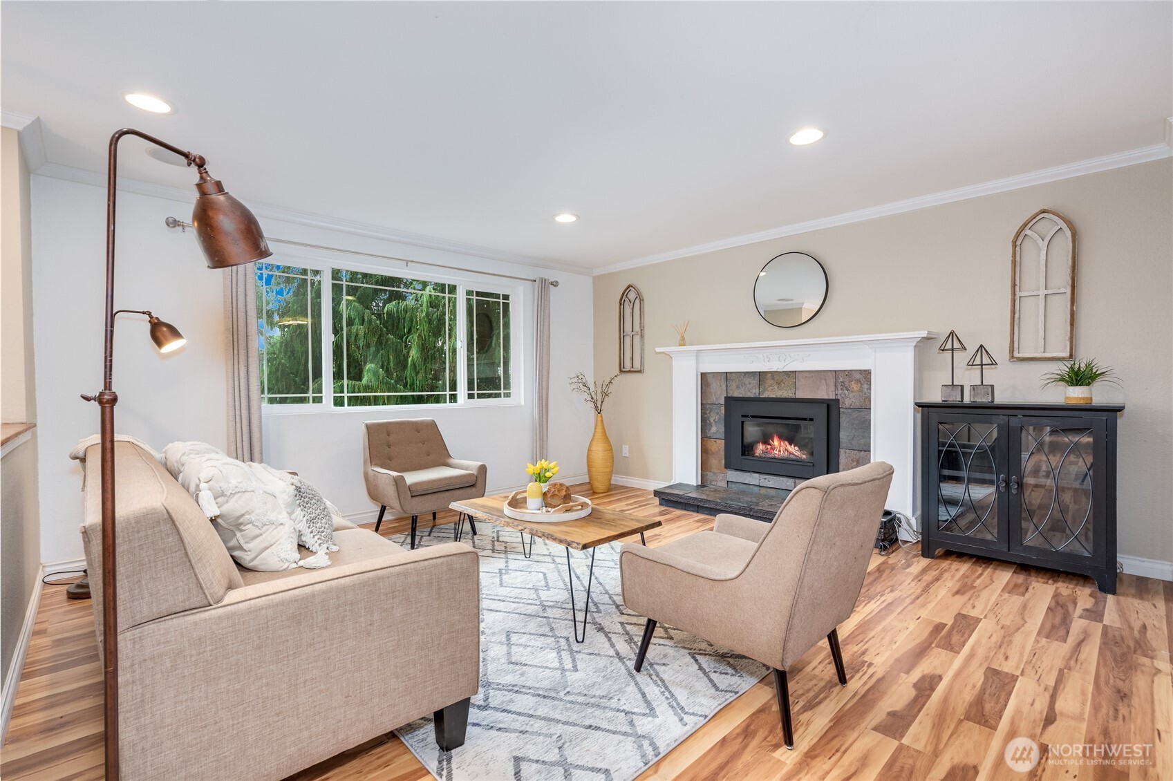 3113 198th Place Southeast Bothell, WA 98012 - Photo 3 of 32 a living room with furniture a fireplace and a table