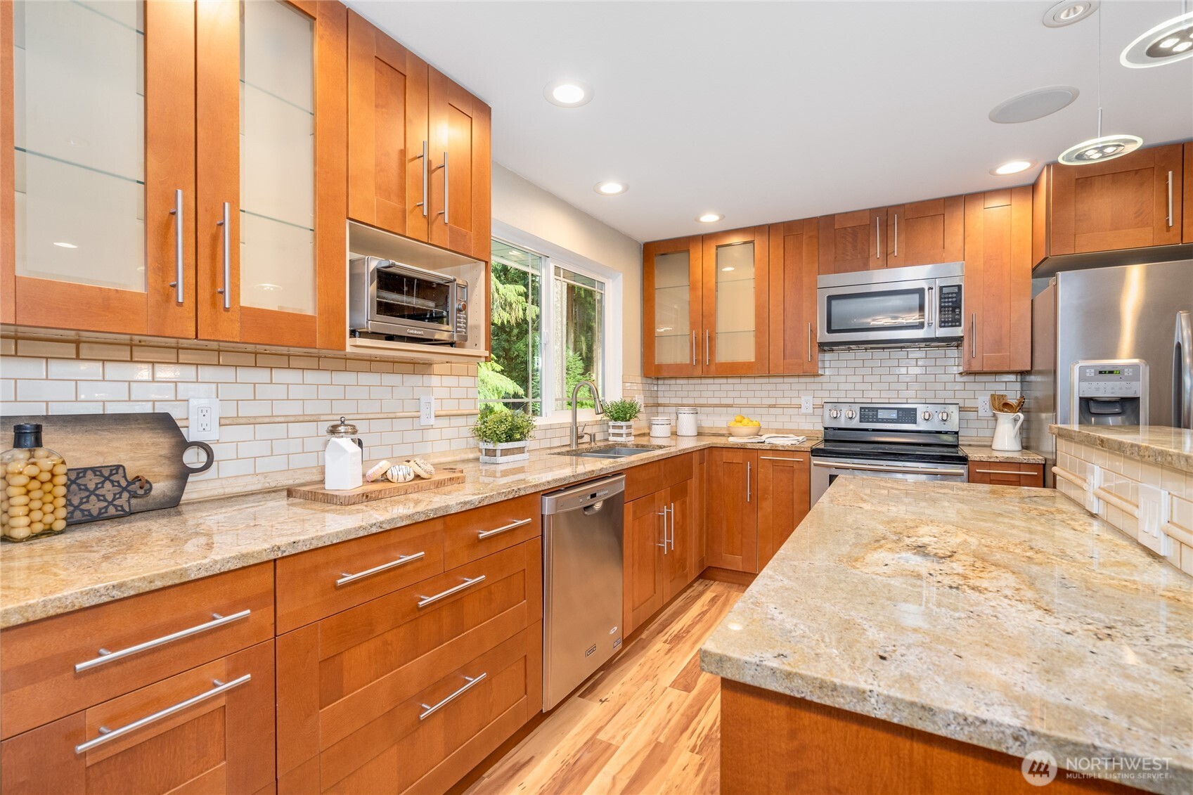 3113 198th Place Southeast Bothell, WA 98012 - Photo 7 of 32 a kitchen with stainless steel appliances granite countertop wooden cabinets a stove and a sink
