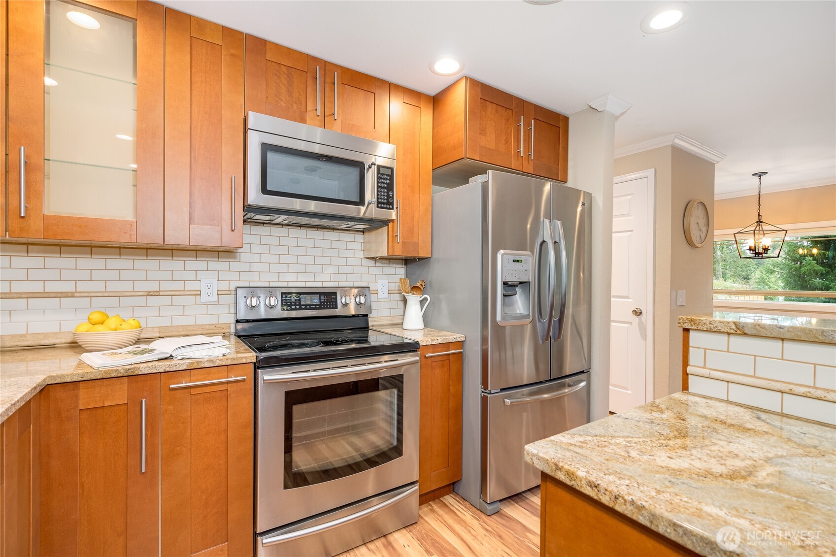 3113 198th Place Southeast Bothell, WA 98012 - Photo 9 of 32 a kitchen with granite countertop a refrigerator stove and washer
