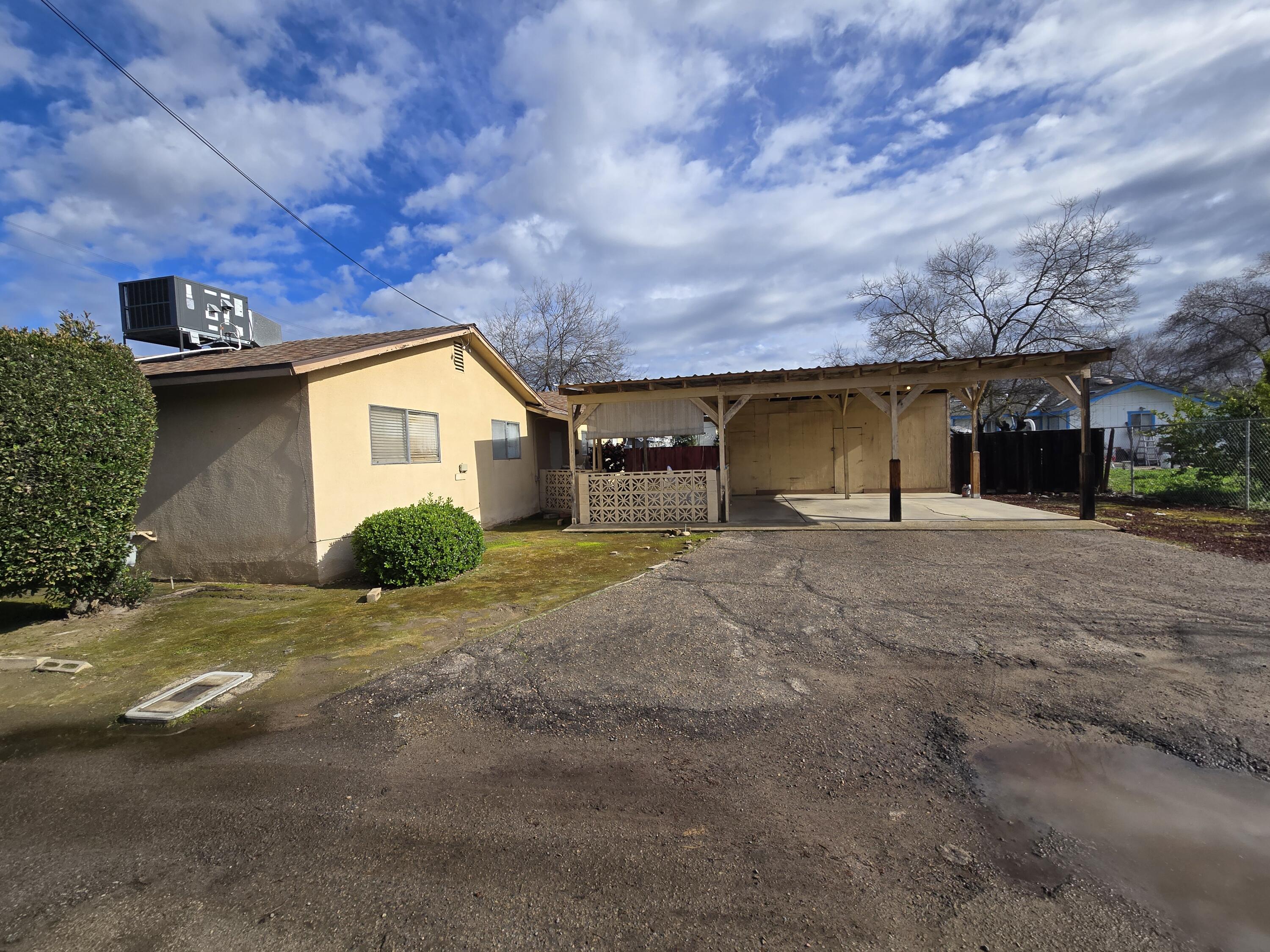 2222-2224 11th Street Reedley, CA 93654 - Photo 5 of 11 a view of a house with a yard and garage