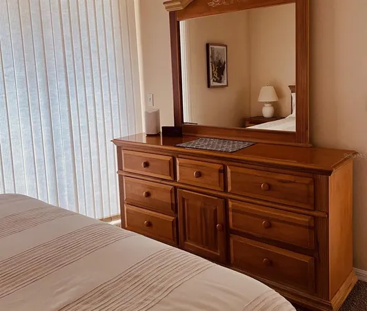 a bedroom with a bed and a dresser