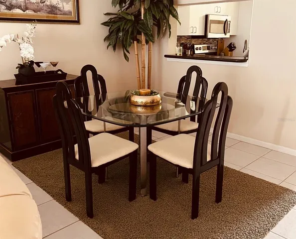 a view of a dining room with furniture and chandelier