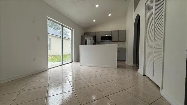 a view of a kitchen with a sink and a refrigerator
