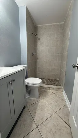 a bathroom with a shower and a toilet