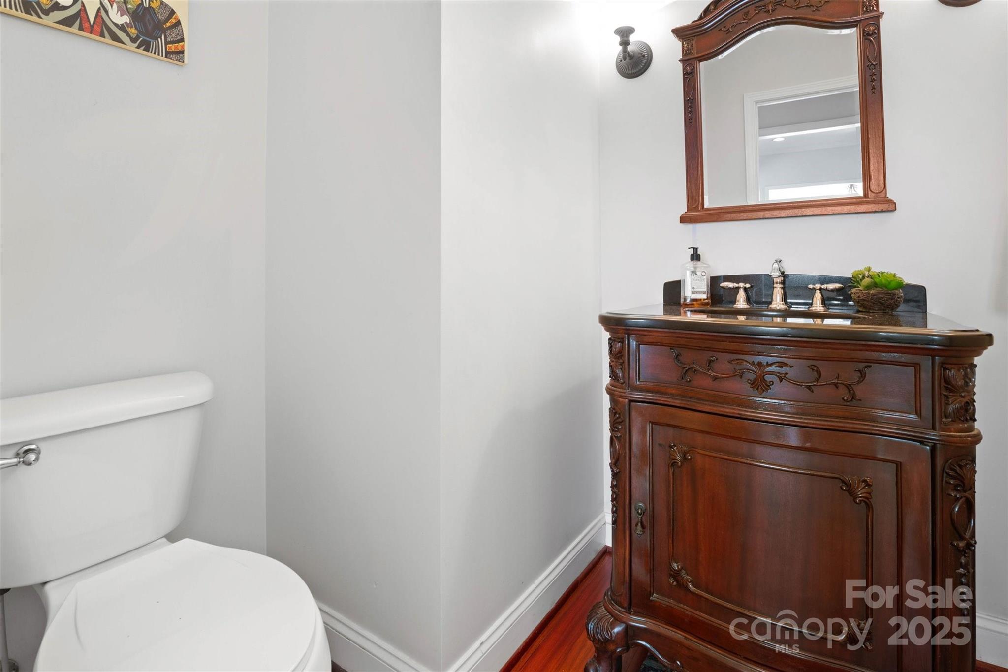 1421 Ashford Road Chester, SC 29706 - Photo 16 of 48 a bathroom with a toilet a sink and mirror