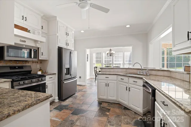 a kitchen with cabinets stainless steel appliances and a counter space