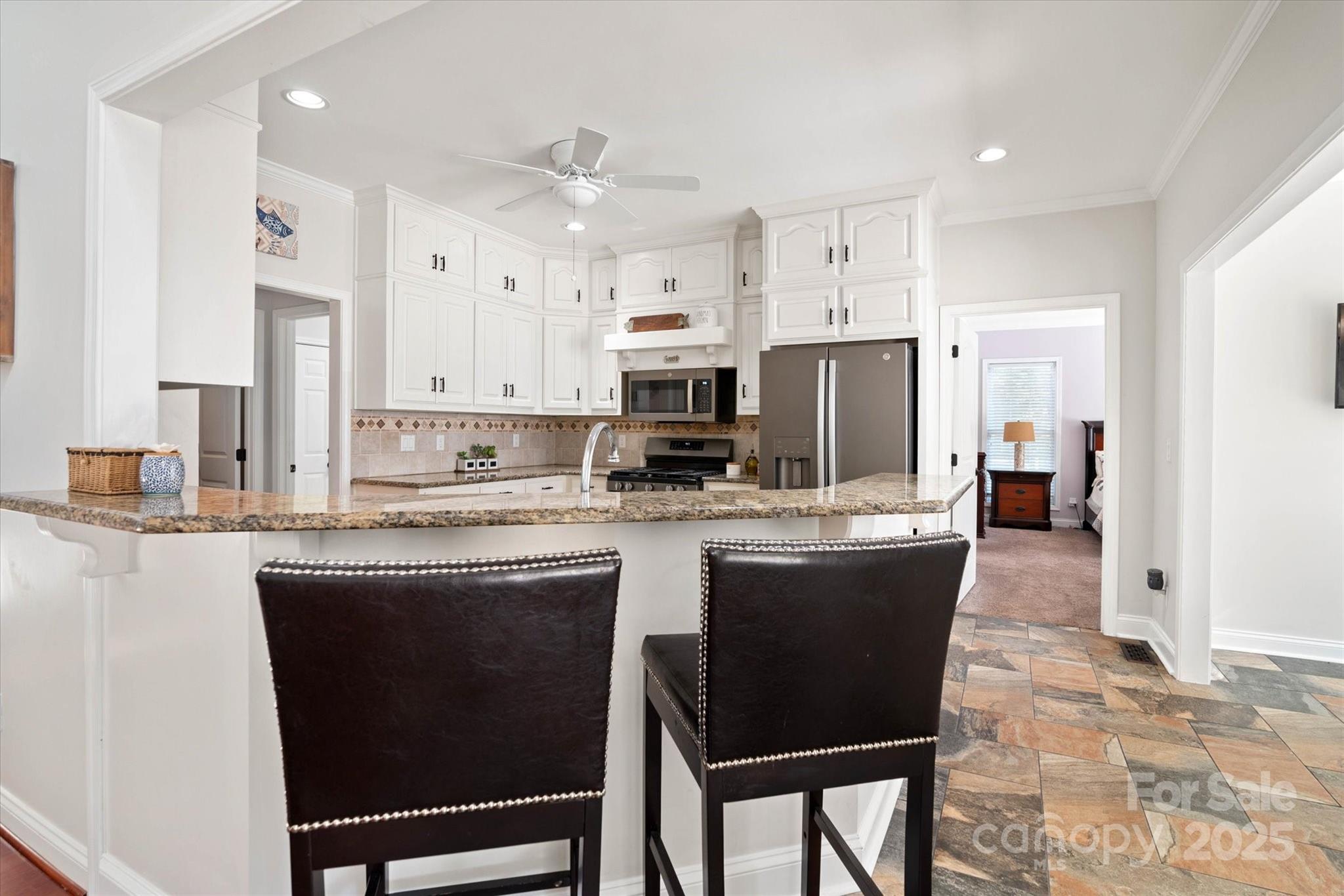 1421 Ashford Road Chester, SC 29706 - Photo 21 of 48 a kitchen with kitchen island granite countertop a sink and cabinets
