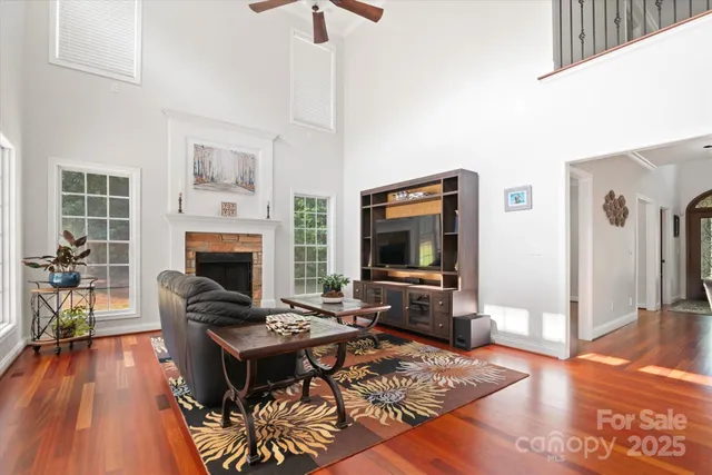 a living room with furniture wooden floor and a fireplace