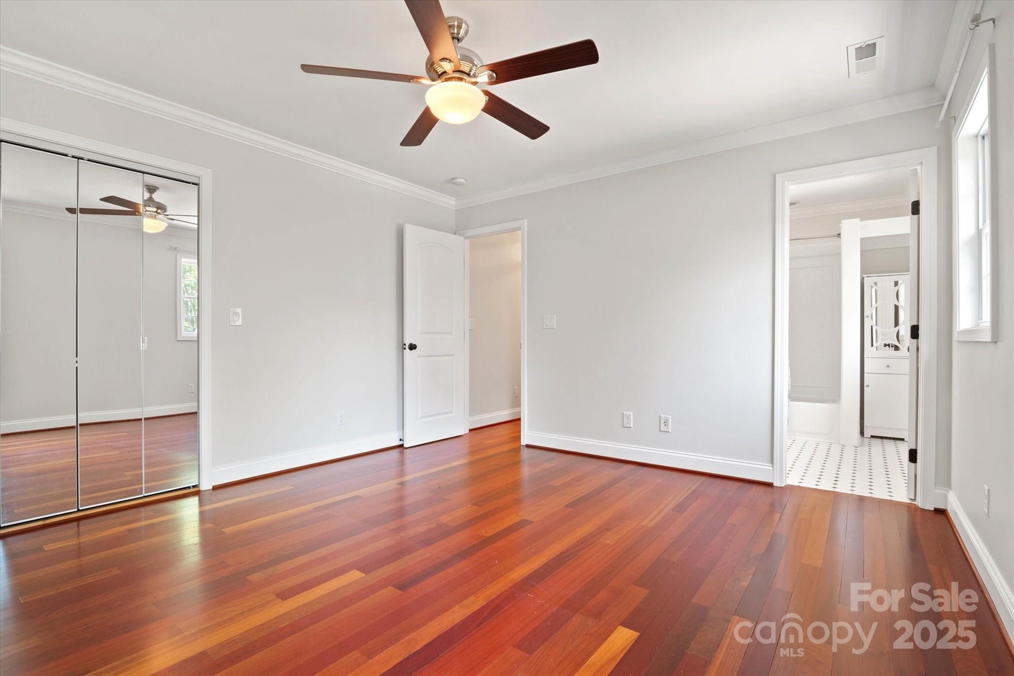 1421 Ashford Road Chester, SC 29706 - Photo 36 of 48 an empty room with wooden floor a ceiling fan and windows
