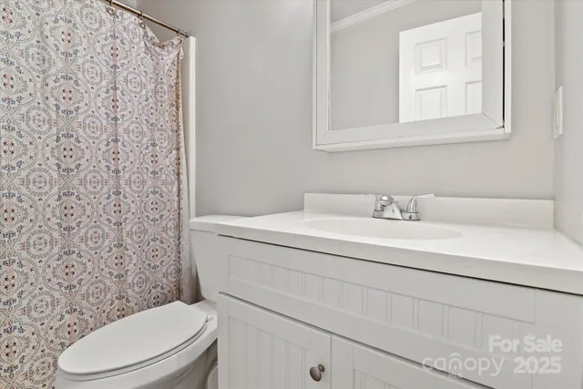 a spacious bedroom with a bed and a chandelier