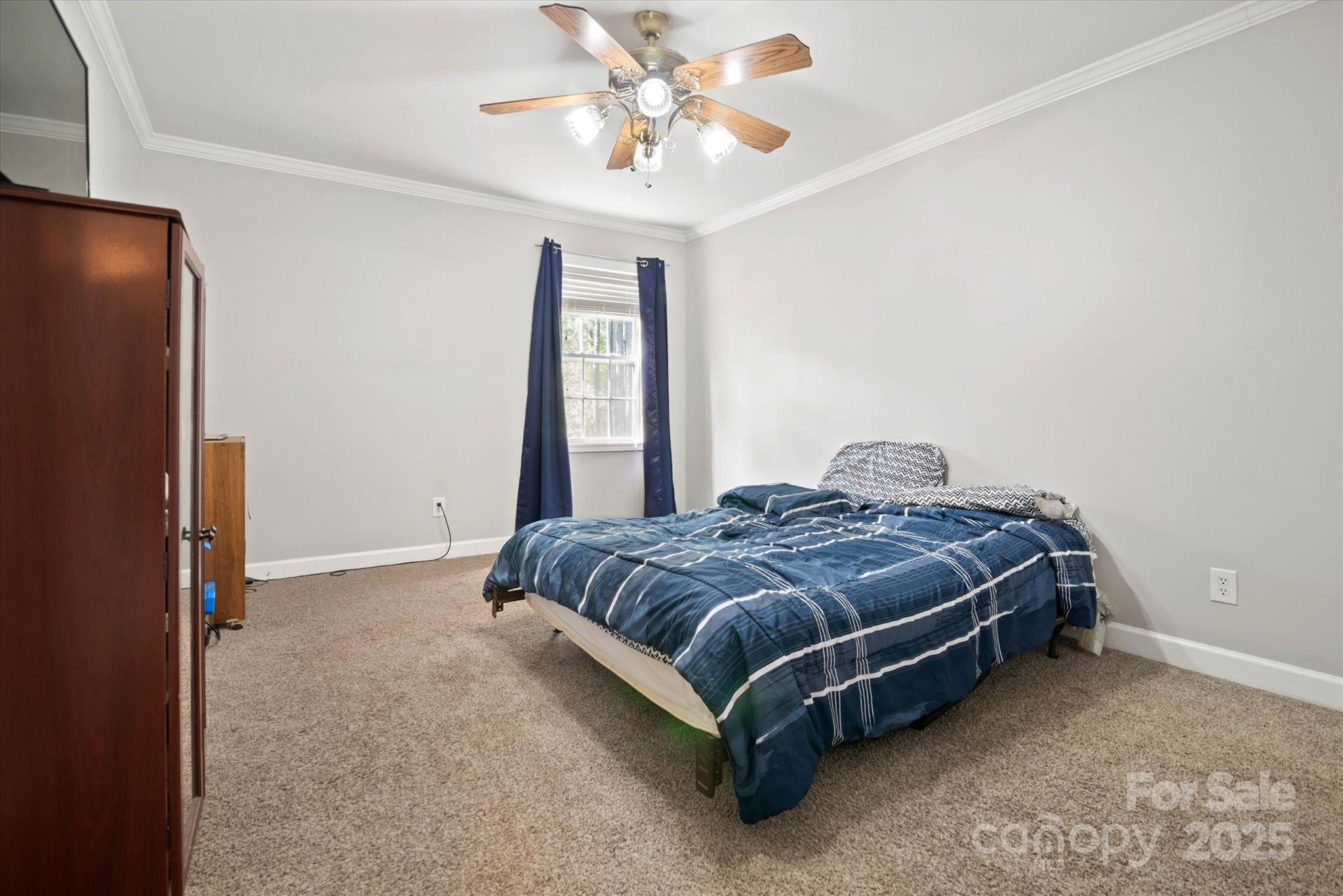 1421 Ashford Road Chester, SC 29706 - Photo 46 of 48 a spacious bedroom with a bed and a chandelier