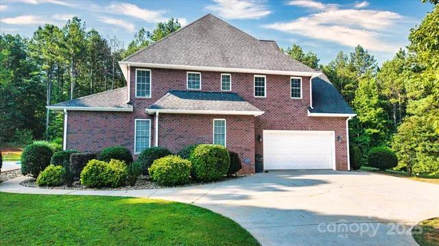 a view of swimming pool with lawn chairs and plants