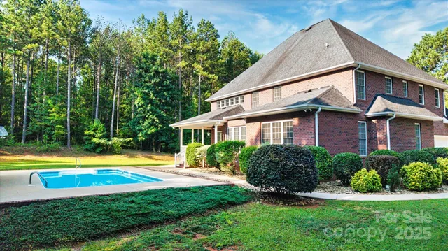 a view of a house with swimming pool and porch