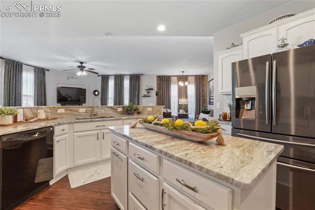 6435 Coyote Ridge Court Colorado Springs, CO 80923 - Photo 13 of 50 a kitchen with counter top space sink and stainless steel appliances