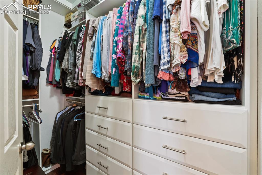 6435 Coyote Ridge Court Colorado Springs, CO 80923 - Photo 27 of 50 a view of walk in closet with clothes and shoes