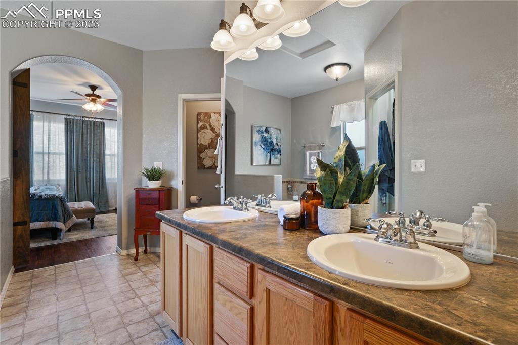 6435 Coyote Ridge Court Colorado Springs, CO 80923 - Photo 28 of 50 a bathroom with a sink double vanity and a mirror