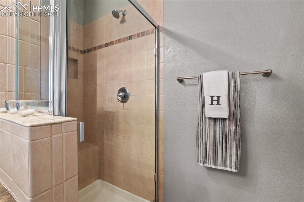6435 Coyote Ridge Court Colorado Springs, CO 80923 - Photo 29 of 50 a bathroom with a sink toilet and shower
