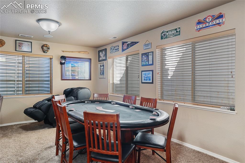 6435 Coyote Ridge Court Colorado Springs, CO 80923 - Photo 36 of 50 a view of a dining room with furniture and window
