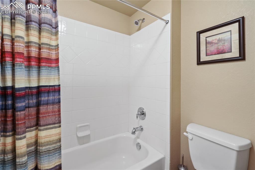 6435 Coyote Ridge Court Colorado Springs, CO 80923 - Photo 39 of 50 a white toilet sitting next to a shower