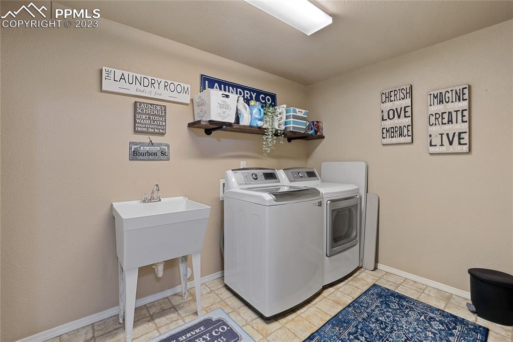 6435 Coyote Ridge Court Colorado Springs, CO 80923 - Photo 44 of 50 a utility room with dryer and washer