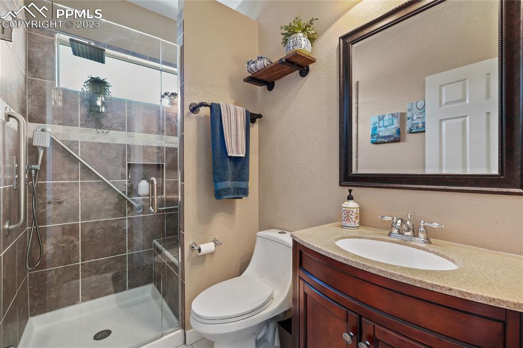 6435 Coyote Ridge Court Colorado Springs, CO 80923 - Photo 6 of 50 a bathroom with a sink toilet and shower