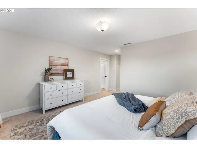 a bedroom with a bed and a dresser