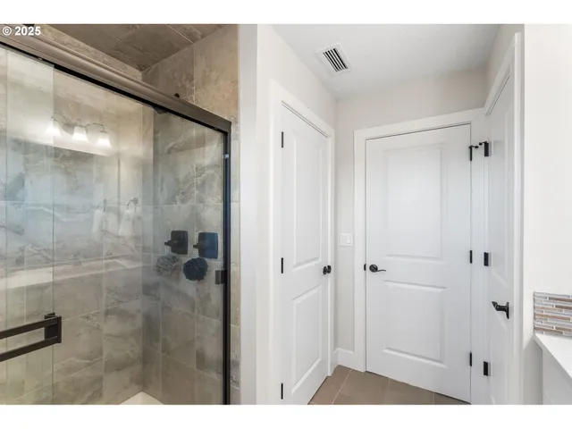 a bathroom with a shower and a sink