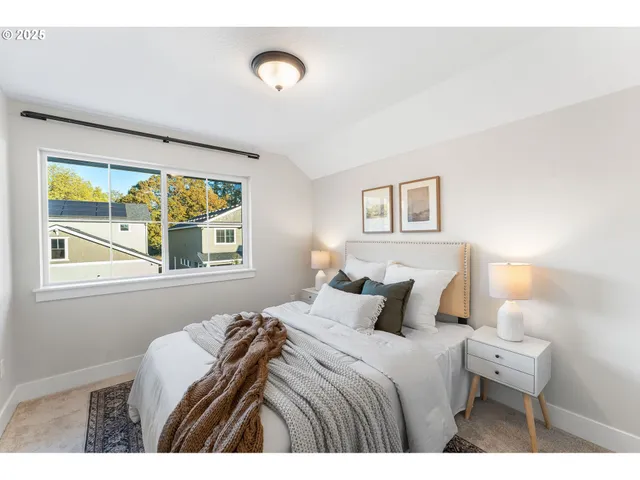 a bedroom with a bed and a painting on the wall
