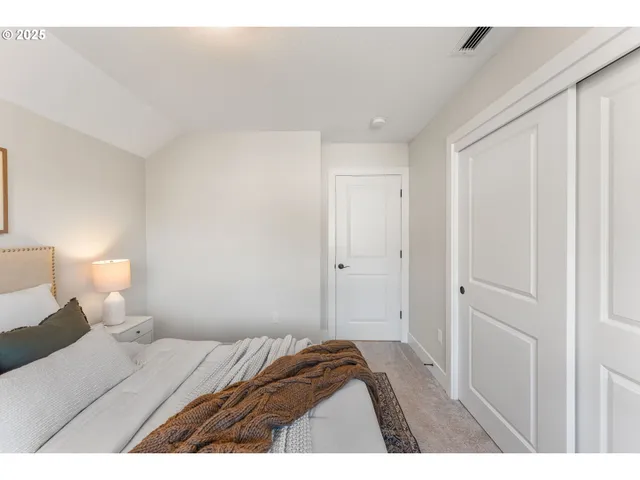 a bedroom with a bed and a lamp