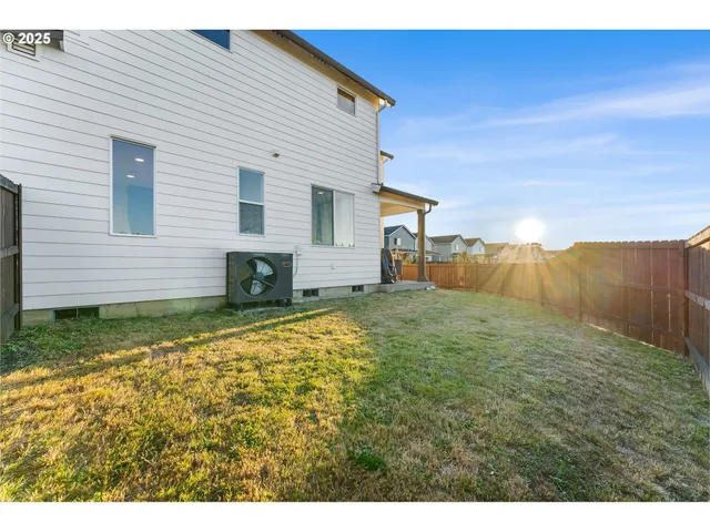 a view of a backyard with large trees