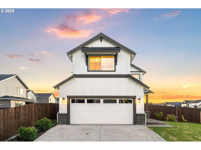 a view of a house with a wooden fence