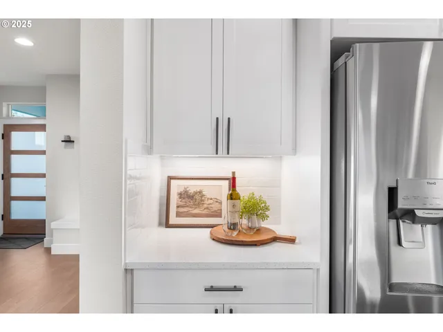 a kitchen with stainless steel appliances wooden cabinet and a refrigerator