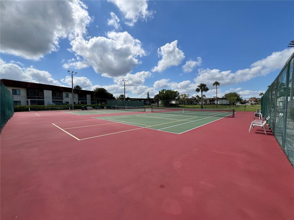 4186 27th Court Southwest, Unit 105 Naples, FL 34116 - Photo 12 of 14 a view of a tennis court