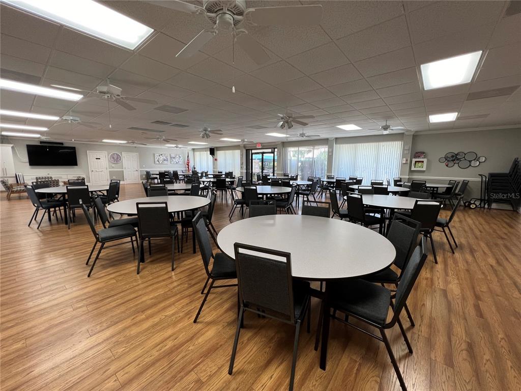 4186 27th Court Southwest, Unit 105 Naples, FL 34116 - Photo 13 of 14 a view of a dining area with furniture and wooden floor