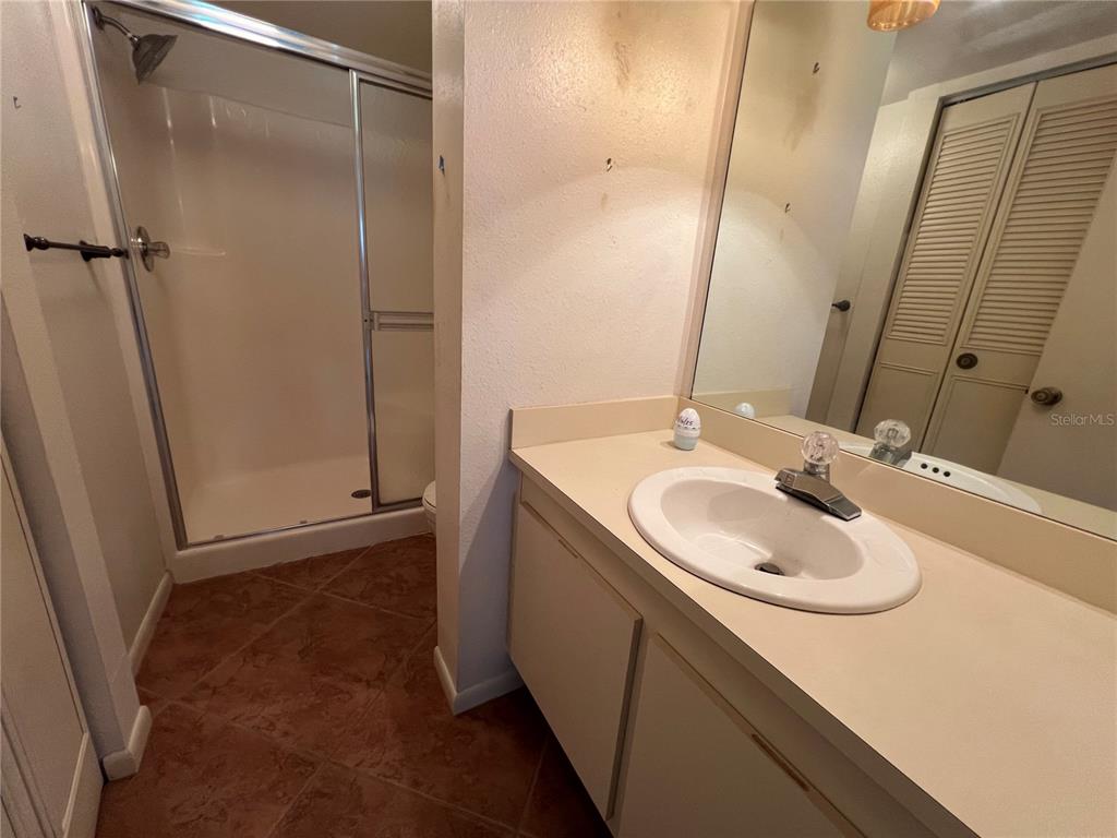 4186 27th Court Southwest, Unit 105 Naples, FL 34116 - Photo 6 of 14 a bathroom with a sink and a mirror