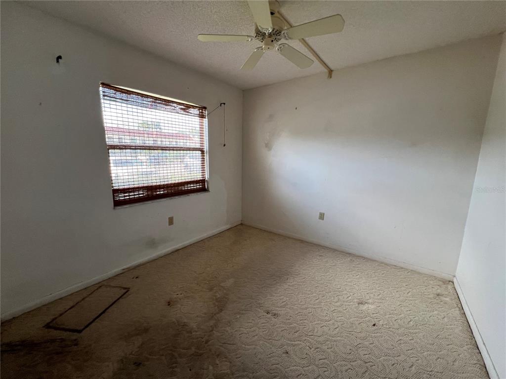 4186 27th Court Southwest, Unit 105 Naples, FL 34116 - Photo 7 of 14 an empty room with a window