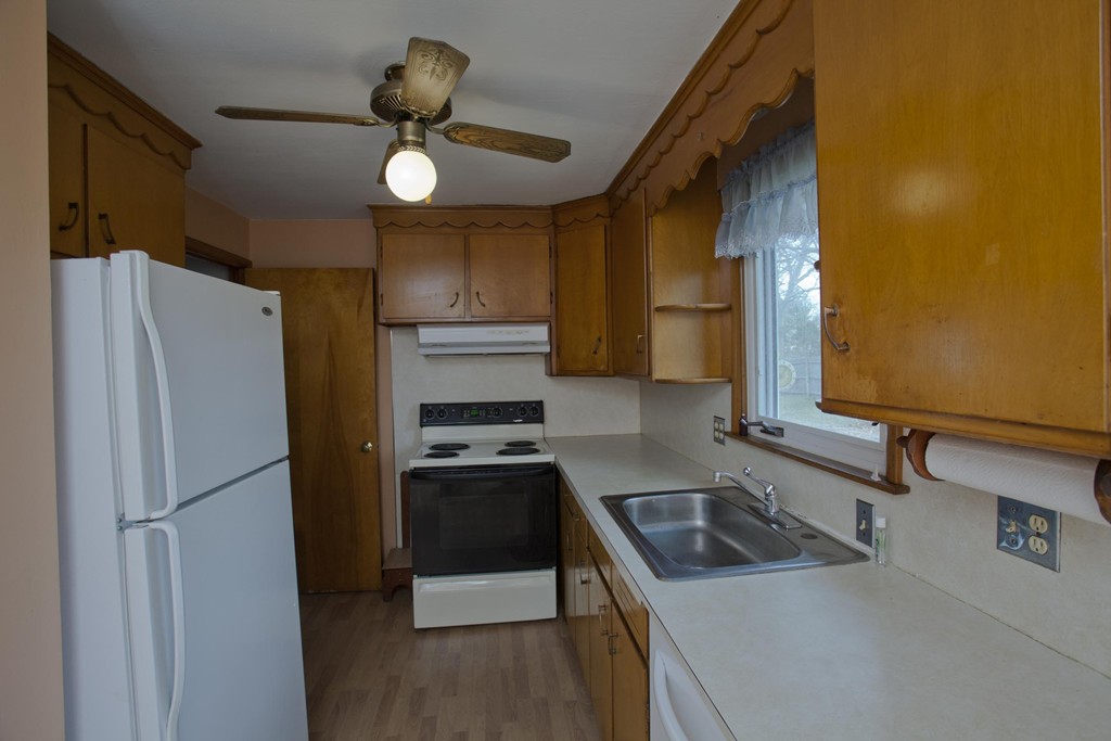 167 Middle Street Springfield, MA 01104 - Photo 8 of 25 a kitchen with a refrigerator a sink and a stove